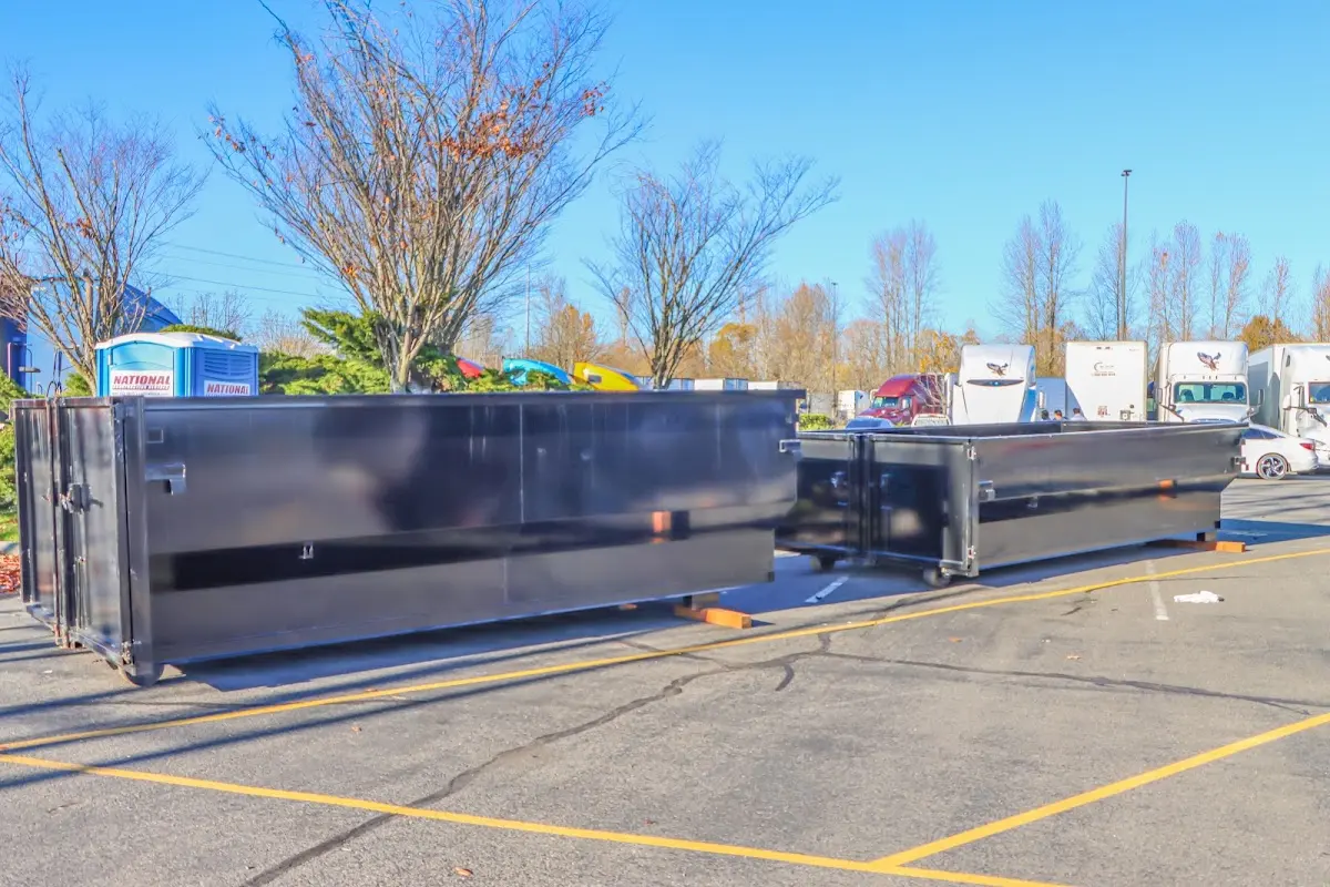 Professional dumpster rental service with roll-off container on residential driveway in McFarland